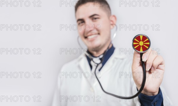 Doctor showing stethoscope with North Macedonia flag. North Macedonia national healthcare concept