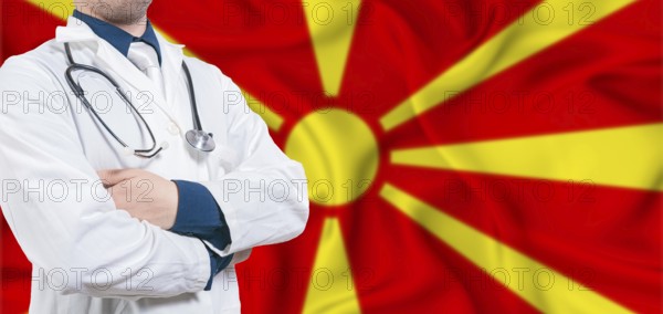 North Macedonia healthcare concept. Male doctor on North Macedonia flag. Doctor with crossed arms on North Macedonia flag