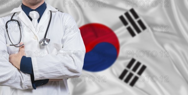 Male doctor with stethoscope on South Korea flag. Doctor holding stethoscope on South Korea flag