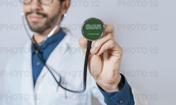 Doctor holding stethoscope with Saudi Arabia flag. Saudi Arabia health and care concept, Saudi Arabia flag on stethoscope