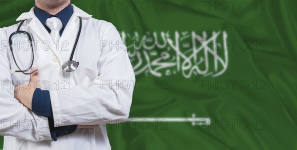 Male doctor with stethoscope on Saudi Arabia flag. Doctor holding stethoscope on Saudi Arabia flag