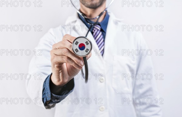 South Korea healthcare system, doctor holding stethoscope. South Korea health and medical insurance concept