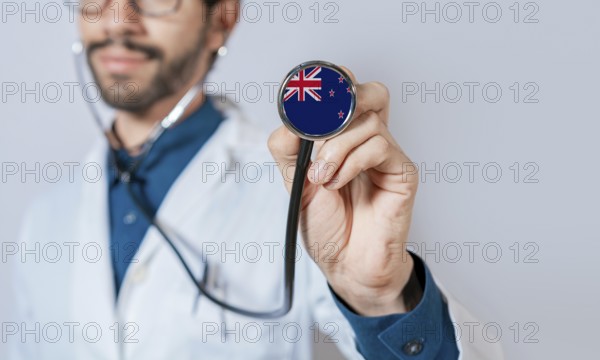 Doctor holding stethoscope with New Zealand flag. New Zealand health and care concept, New Zealand flag on stethoscope