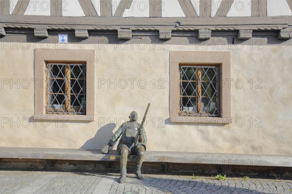 Sculpture Herbert König Suhl original in front of the arms museum, bronze sculpture, hunter with shotgun, rifle, sitting, Suhl, Franconia, Thuringia, Germany