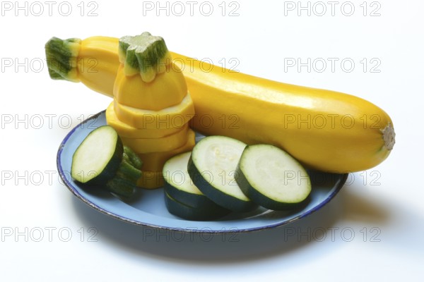 Green and yellow courgettes on a plate, Cucurbita pepo
