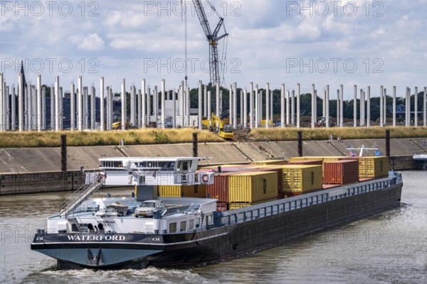 Construction of a new logistics hall on the Mercatroinsel, Hall 2, next to an existing hall, approx. 25, 000 square metres in size, in Duisburg-Ruhrort, shell construction, container freighter leaving the Vincke Canal for the Rhine, North Rhine-Westphalia, Germany