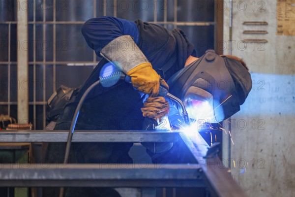 Germany - Theme photo metal industry. An industrial welder welds a workpiece