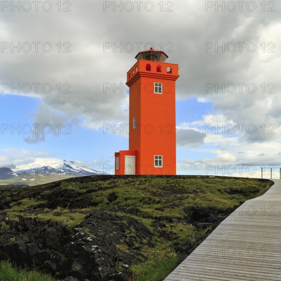 Orange lighthouse Skálasnagaviti or Svörtuloft with volcano Snaefell Snaefellsjökull glacier, Skalasnagi, Öndverdarnes, Snæfellsnes peninsula, Snaefellsnes, Iceland