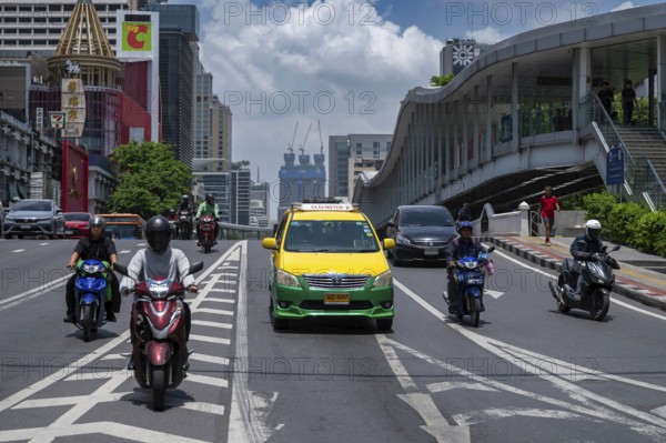 Road traffic taxi and motorbike scooter, Bangkok, Thailand