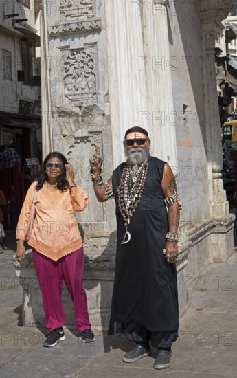 Indian couple, tattooed, with skull chains at Gangaur Ghat or Gangori Ghat, Udaipur, Rajasthan, India