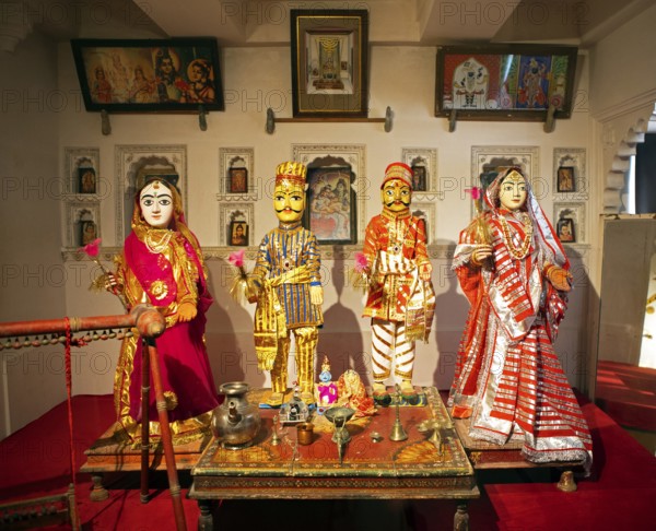 Indian traditional woman and men, dolls, worshipping Radha Krishna in the City Palace Museum, City Palace of Udaipur, Rajasthan, India