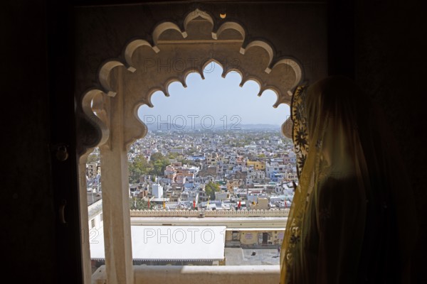 Indian woman with headscarf looking at the city, City Palace Museum, City Palace or City Palave, Udaipur, Rajasthan, India