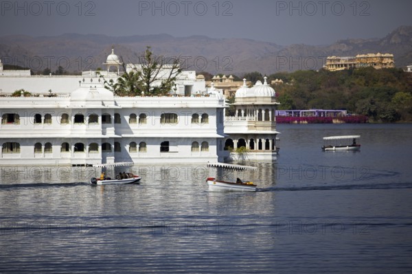 Boats on Lake Pichola, behind the Taj Lake Palace Hotel, Udaipur, Rajasthan, India