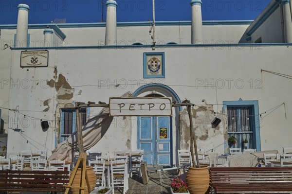 Outdoor terrace of a restaurant with blue and white façade and floral decoration, Agia Marina, Leros, Dodecanese, Greek Islands, Greece