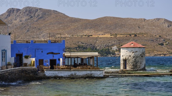 Restaurant Mylos, coastal landscape with blue buildings and a windmill by the sea, Agia Marina, Leros, Dodecanese, Greek Islands, Greece