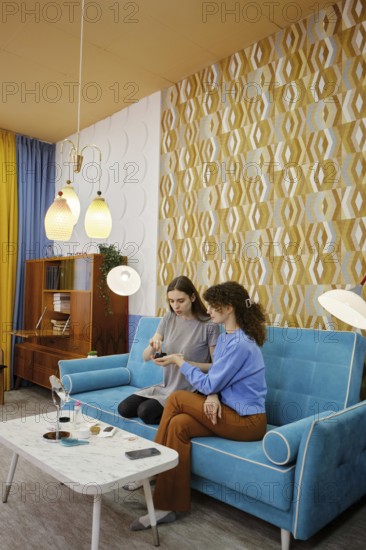 Young woman is going to put patches under her eyes and her friend holds an open jar of patches