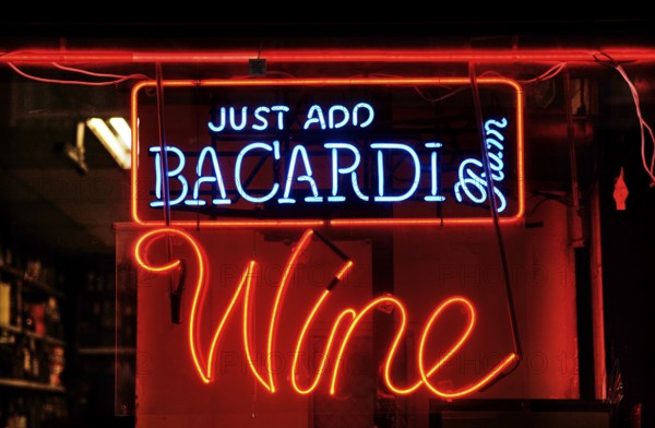 Illuminated advertising at a bar, New York City, USA