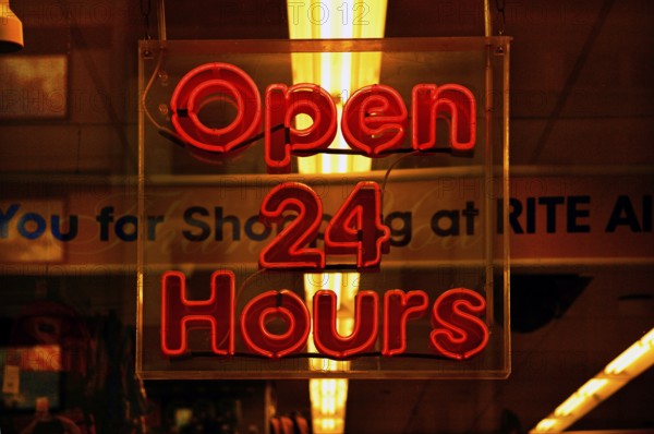 Illuminated sign Open 24 Hours in a shop, New York City, USA