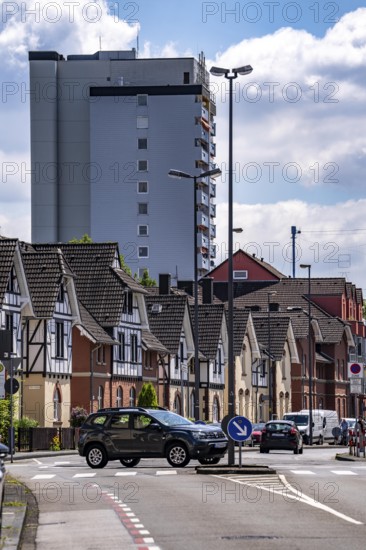 Residential buildings, on Nobelstrasse, in the Wiesdorf district, in Leverkusen, Bayer AG's Plant Estate II, heritage-protected building, in the background residential tower block and Bayer Cross in Chempark Leverkusen, North Rhine-Westphalia, Germany