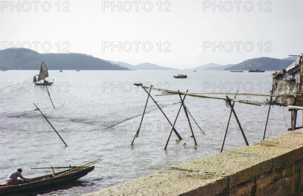 Fishing nets and boats on coastline, Macau, Asia 1964 thought to now be Sai Van Lake, Lago Sai Van