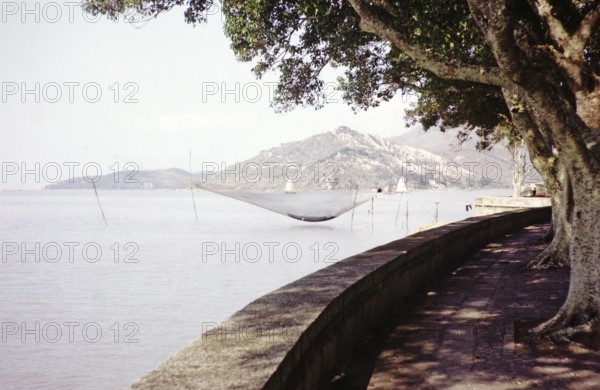 Fishing nets and boats on coastline, Avenida da Republica, Macau, Asia 1964 now Sai Van Lake, Lago Sai Van