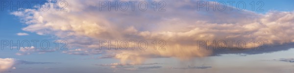 Wallpaper for sky replacement, evening sky with illuminated clouds, soft pastel colours and rain showers in the evening light