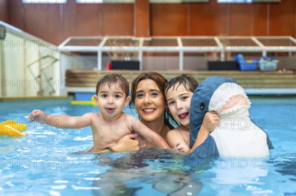 Happy family enjoying time together, playing with inflatable toy in swimming pool during summer vacation