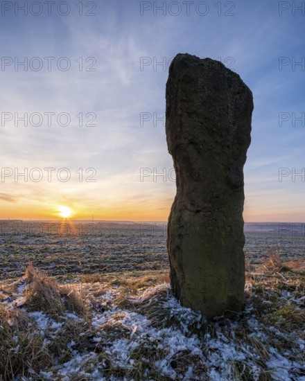 The menhir of Saubach at sunrise in winter, also called Hinkelstein, Heidenstein, Langer Stein, Bad Bibra, Saxony-Anhalt, Germany