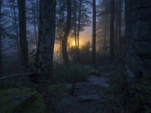 Dark forest with fog at dusk, the lights of a lonely house shine mysteriously out of the darkness, Gasthaus Waldsteinhaus am großen Waldstein, Fichtelgebirge, Upper Franconia, Bavaria, Germany
