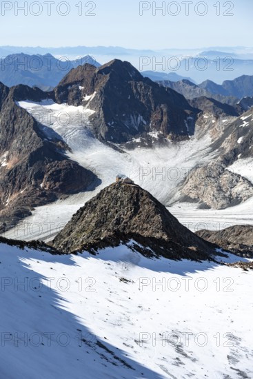 At the Wilder Freiger summit, picturesque high mountain landscape with snow, view of the Übeltalferner glacier and rocky mountain peaks Becher with Becherhaus and Königshofspitz, Stubai Alps, South Tyrol, Italy