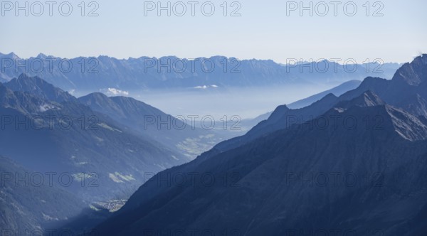 View of the Stubai Valley, mountain silhouettes, from the summit of the Wilder Freiger, Stubai Alps, South Tyrol, Italy