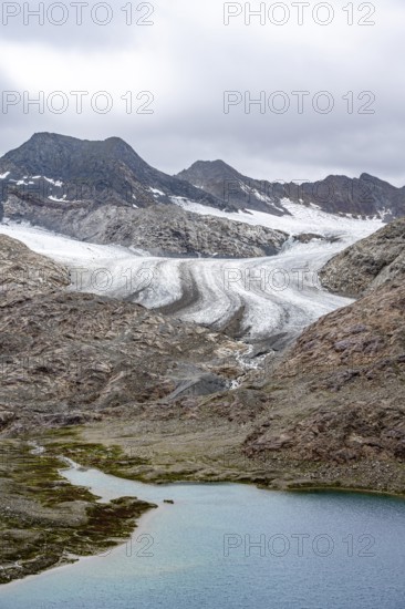 High mountain landscape with glacier tongue of the Übeltalferner and mountain lake Vogelhüttensee, Stubai Alps, South Tyrol, Italy