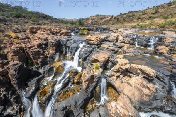 Waterfall on orange-coloured rock cliffs, long exposure, Blyde River, Bourke's Luck Potholes, Panorama Route, Mpumalanga, South Africa