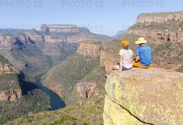 Two hikers enjoying panorama, Blyde River Canyon with Three Rondawels peak, view of gorge with Blyde River and table mountains, canyon landscape, Panorama Route, Mpumalanga, South Africa