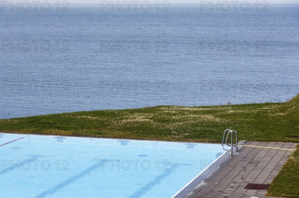 View from above of swimming pool by the sea, thermal bath, heated outdoor pool in Hofsos at the fjord Skagafjördur, Lake Greenland, Hofsos, Tröllaskagi peninsula, Nordurland vestra, North Iceland, Iceland