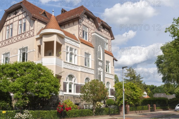 Living in the Schwachhausen district, façade of a Wilhelminian style villa, year 1904, architecture, half-timbered upper storey, corner tower, gardens, Hanseatic city of Bremen, Germany