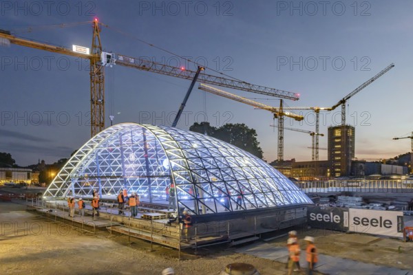 First entrance portal at the new Stuttgart main station completed. One of four so-called lattice shells, which travellers will use to access the underground through station in future, is revealed for the first time. The spectacular steel and glass construction was realised by façade specialist Seele and planned by christoph ingenhoven architects. Stuttgart, Baden-Württemberg, Germany