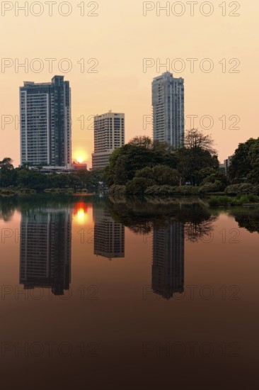 Skyscrapers reflecting in Beira Lake at sunset, Colombo, Sri Lanka