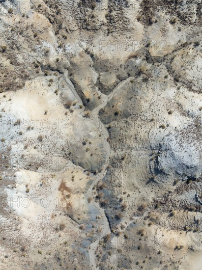 Broken, rocky ground with sparse vegetation. Aerial view. Drone shot. Southern Namibia