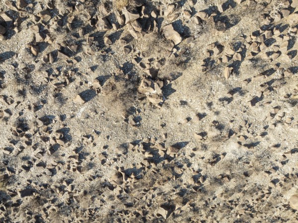 Broken, rocky ground in a dried-up river bed. Aerial view. Drone shot. Southern Namibia