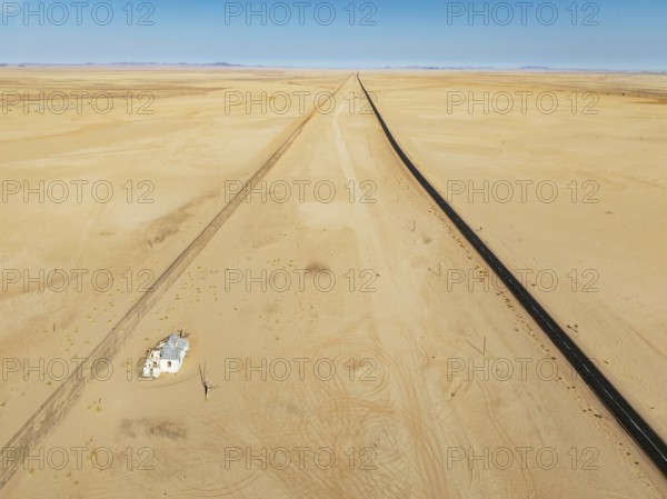 The long abandoned Garum train station and the B4 tarred road in the southern Namib Desert. Aerial view. Drone shot. Namibia