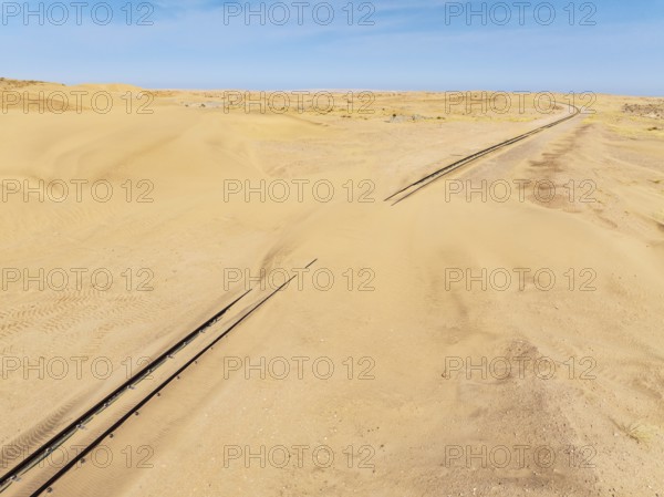 Rails covered with sand in the southern Namib Desert. Aerial view. Drone shot. Namibia