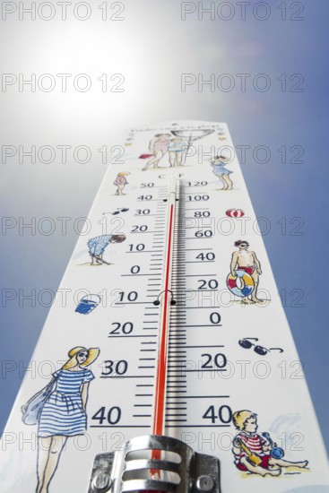 Worm's-eye view of thermometer measures extremely hot temperature of 38 degrees Celsius, 38 °C, 100 °F during heatwave, heat wave in summer