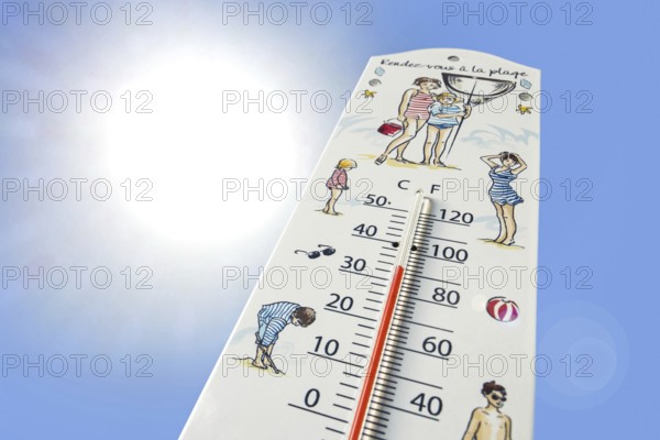 Worm's-eye view of thermometer measures extremely hot temperature of 34 degrees Celsius, 34 °C, 93. 2 °F during heatwave, heat wave in summer