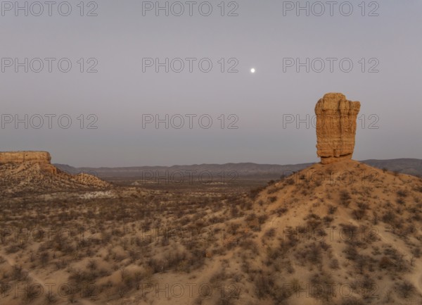 The Vingerklip (rock finger) and the Ugab Valley Terraces are surrounded by thornbush and mopane (Colophospermum mopane) savanna. At dawm with full moon. Aerial view. Drone shot. Damaraland, Namibia