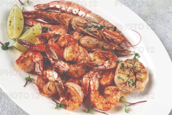 Fried langoustines and tiger shrimps, with spices and herbs, homemade dish, without people
