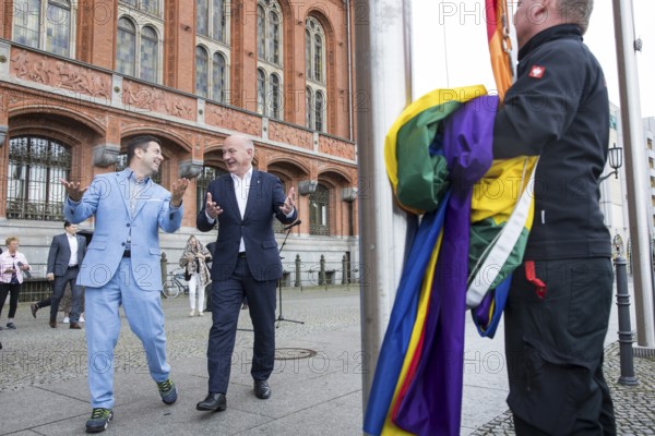 Kai Wegner (Governing Mayor of Berlin) and Florian Winkler-Schwarz, Managing Director of the Lesbian and Gay Federation (LSVD) Berlin Brandenburg laugh on the way to the raising of the rainbow flag for Pride Week in front of the Rotes Rathaus in Berlin on 9 July 2025