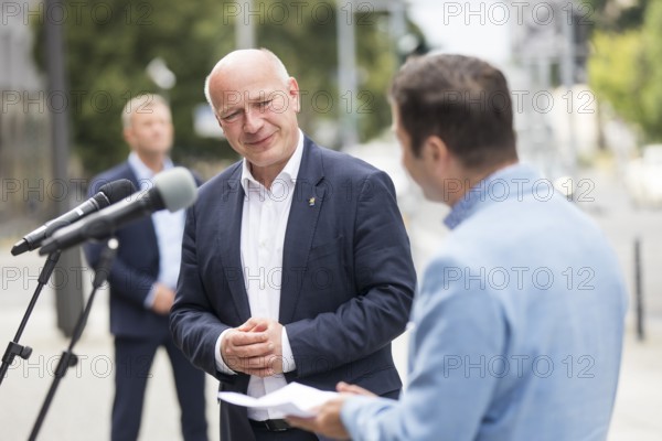 Kai Wegner (Governing Mayor of Berlin) and Florian Winkler-Schwarz, Managing Director of the Lesbian and Gay Federation (LSVD) Berlin Brandenburg in front of the raising of the rainbow flag for Pride Week in front of the Rotes Rathaus in Berlin on 9 July 2025