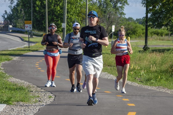 Detroit, Michigan - Runners on a trail that circles Belle Isle, a state park in the Detroit River