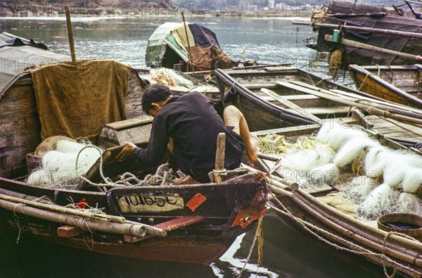 Man working on his sampan boat, Castle Peak, New Territories, Hong Kong, Asia, 1964